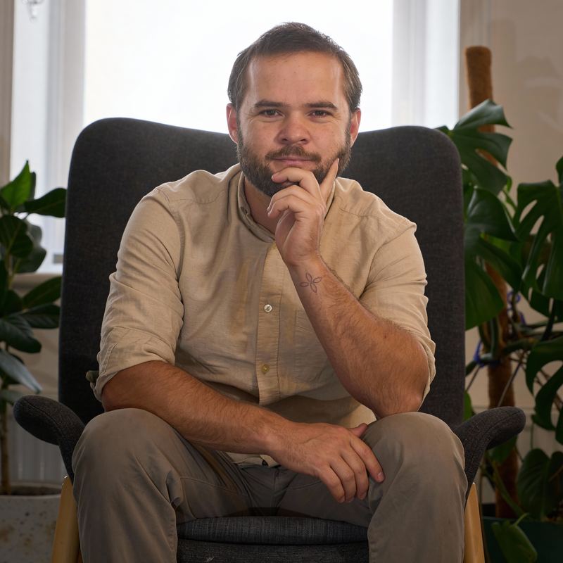 Therapy room with comfortable seating and plants, creating a warm and safe space